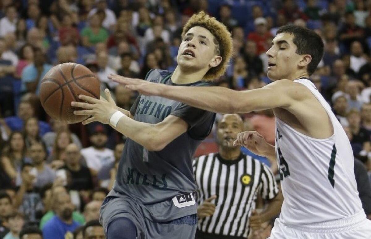 Chino Hills' Lamelo Ball, left, goes to the basket against De La Salle's Jordan Ratinho during the second half of the CIF boys' Open Division championship on March 26.