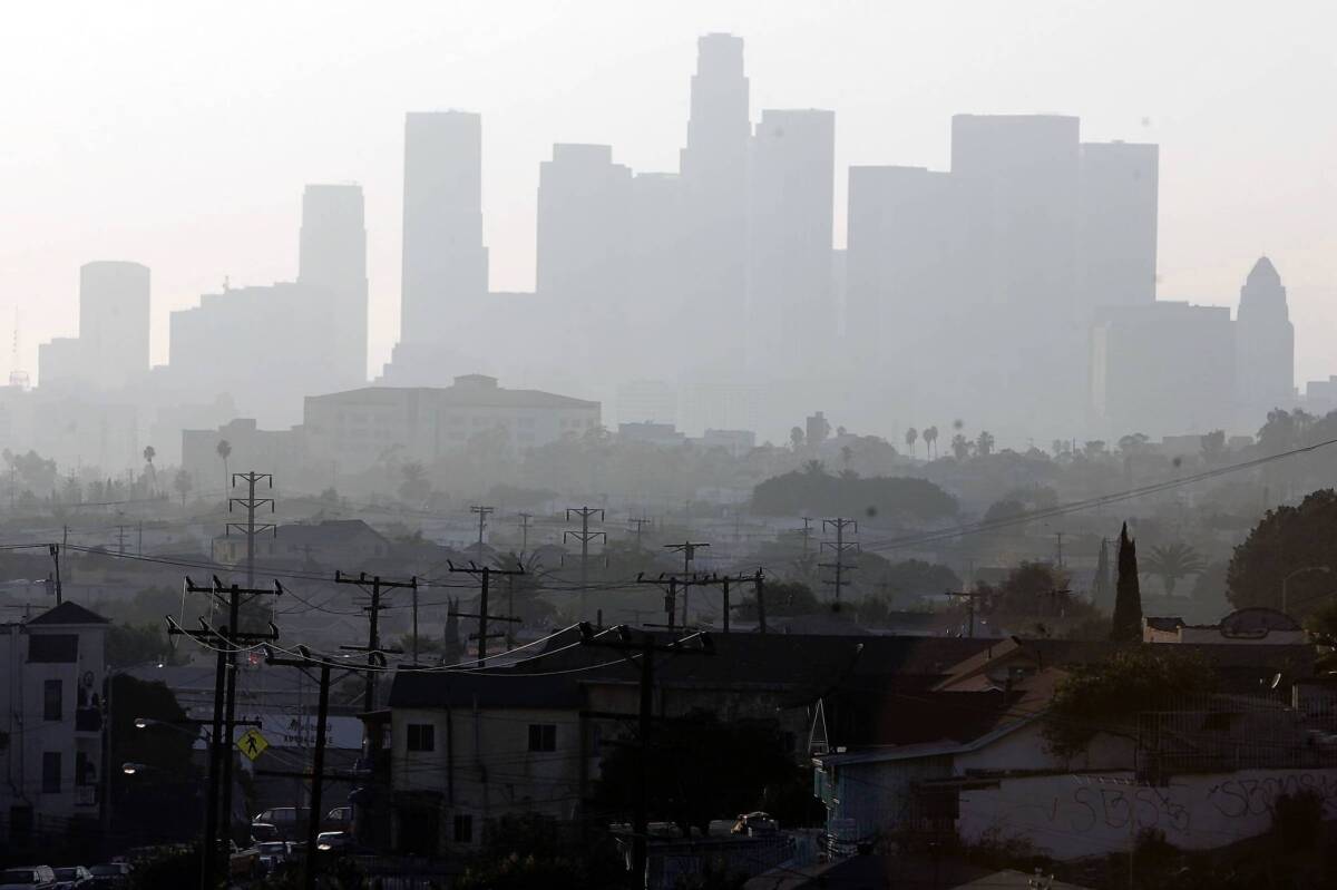 A hazy day in Los Angeles. A new report says California will fall short of its goal to slash greenhouse gas emissions by midcentury unless it adopts aggressive policies to fight climate change.