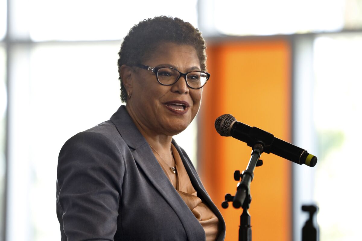 Rep. Karen Bass speaks while standing before a microphone