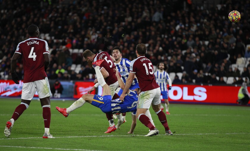 Brighton's Neal Maupay scores his side's opening goal during the English Premier League soccer match between West Ham United and Brighton and Hove Albion in London, England, Wednesday, Dec. 1, 2021. (AP Photo/Ian Walton)