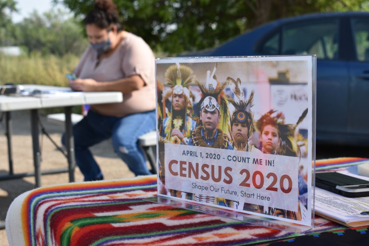 In this 2020 photo, a sign promotes the census to Native Americans near Selena Rides Horse in Montana