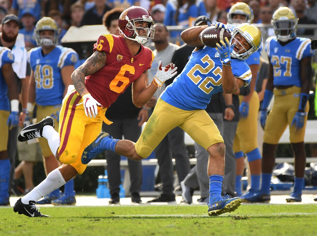 UCLA defensive back Nate Meadors intercepts a pass in front of USC receiver Michael Pittman Jr. in the second quarter Saturday at the Rose Bowl.