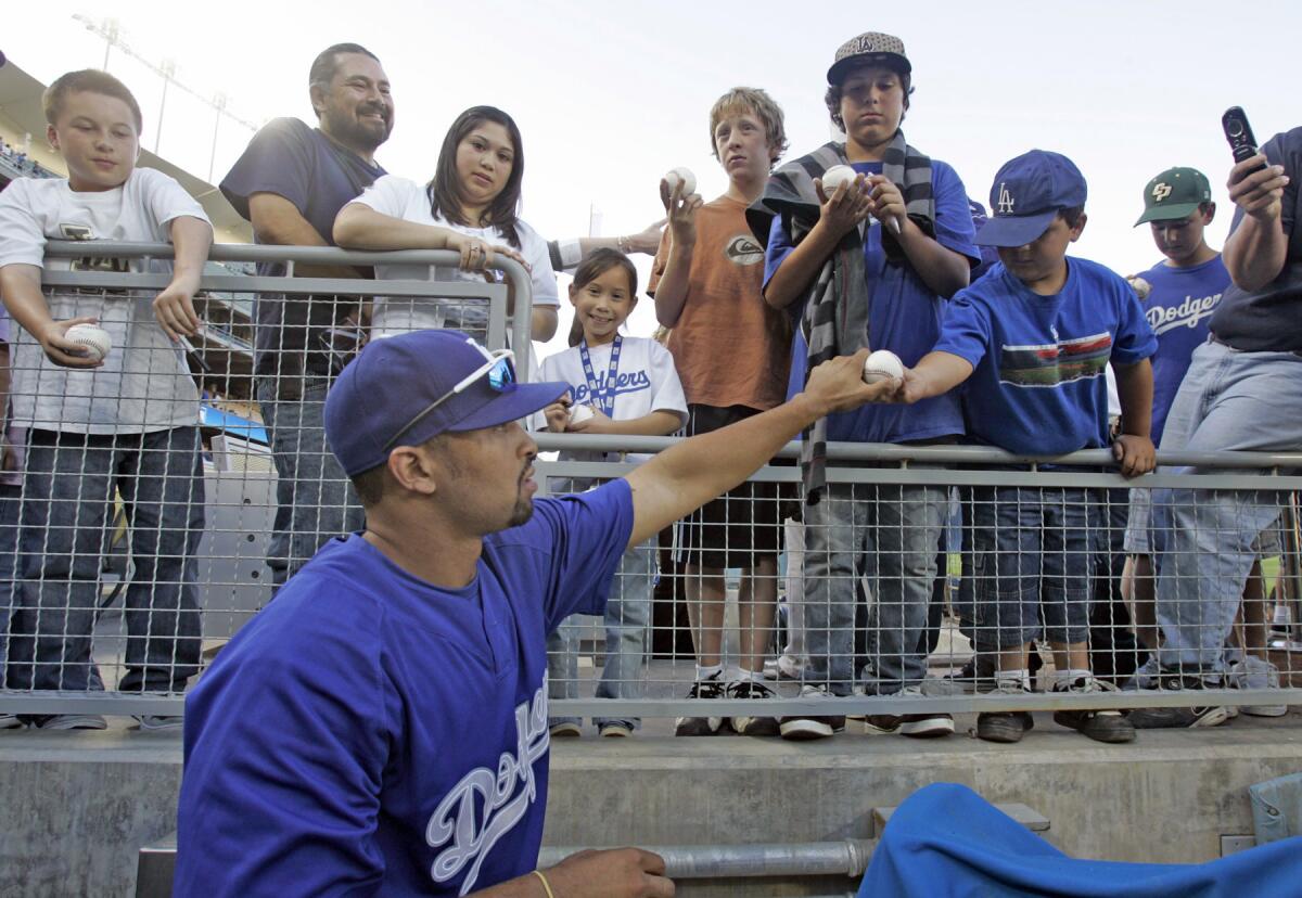 Fans get autographs from Dodgers Matt Kemp before the game against the Padres at Dodger Stadium on April 11, 2008.