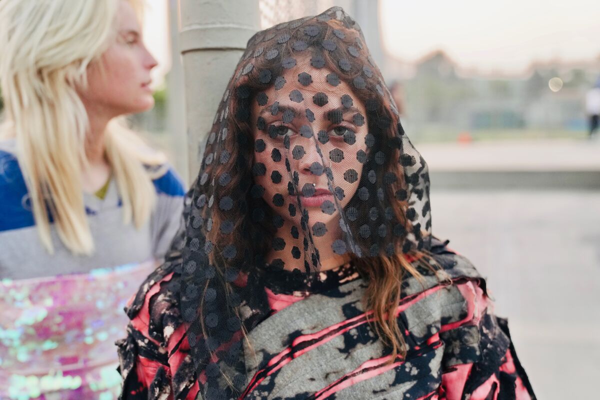 A model in a look from the spring and summer 2021 collection for Imitation of Christ.