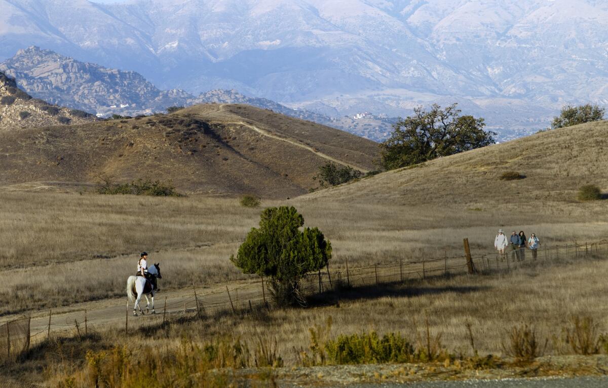 CALABASAS, CA - NOVEMBER 18, 2013: A Horseback rider and hikers enjoy the Upper Las Virgenes Canyon Open Space Preserve on the 10th anniversary of the acquisition of the Ahmanson Ranch on November 17, 2013 in Calabasas, California.(Gina Ferazzi / Los Angeles Times)