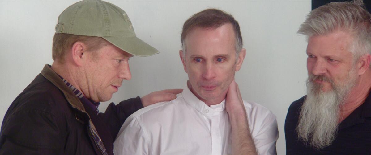 Three men in the documentary “Procession.”