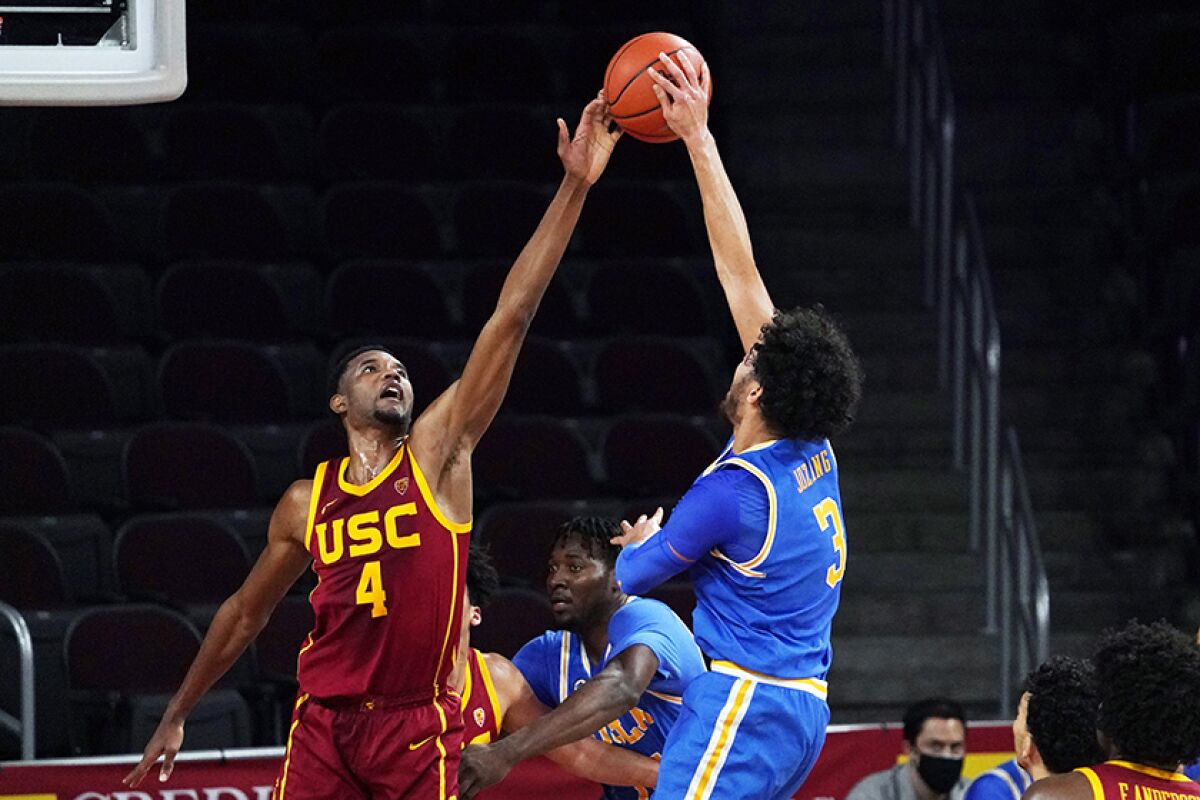 USC's Evan Mobley defends against UCLA's Johnny Juzang during Saturday night's game. 