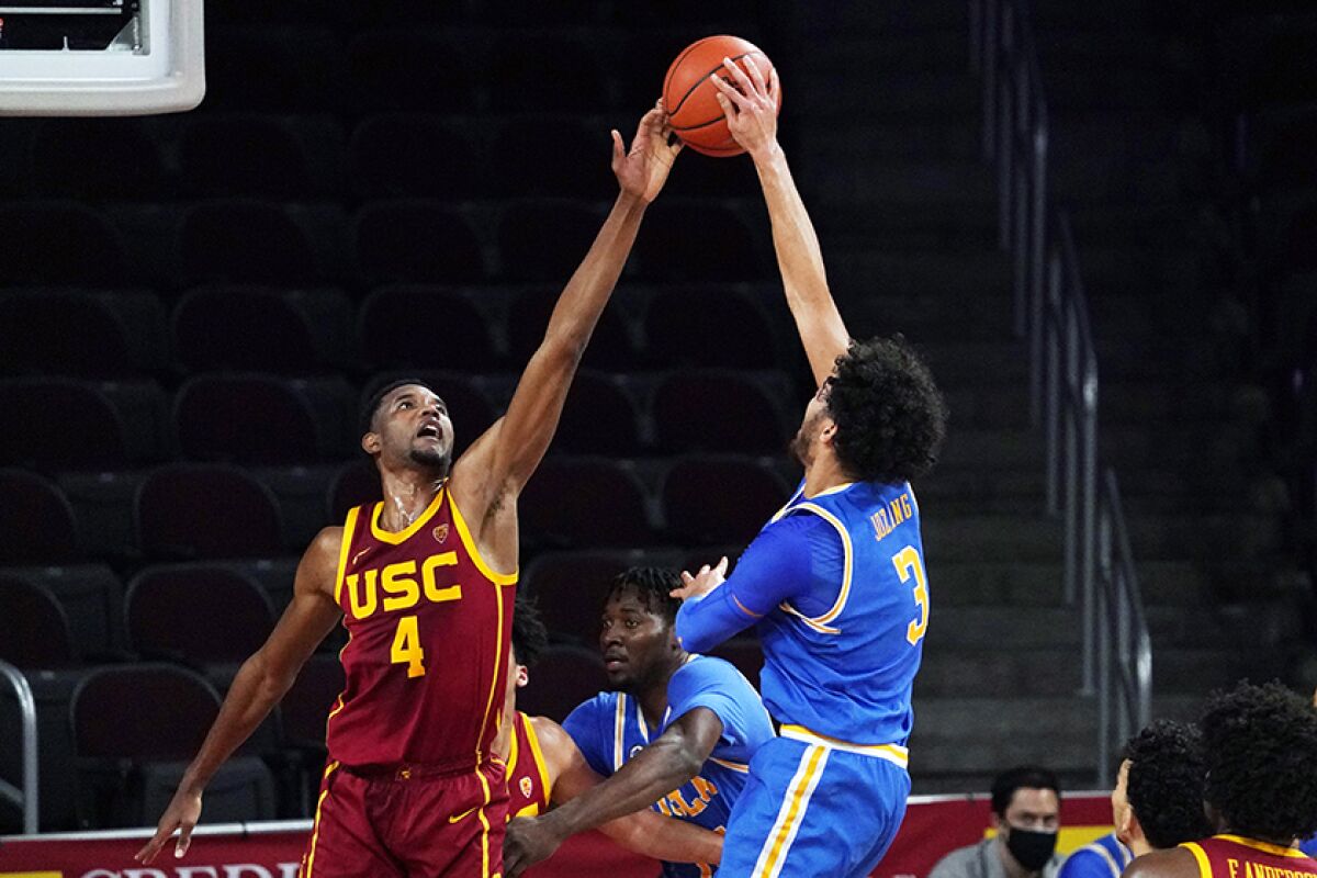USC's Evan Mobley defends against UCLA's Johnny Juzang during Saturday night's game.