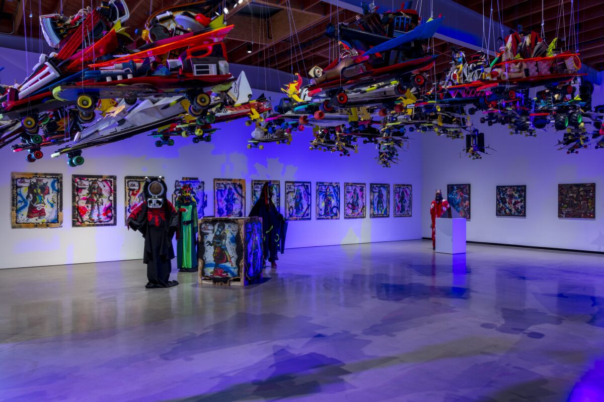 Installation views of paintings, costumes and skateboards.