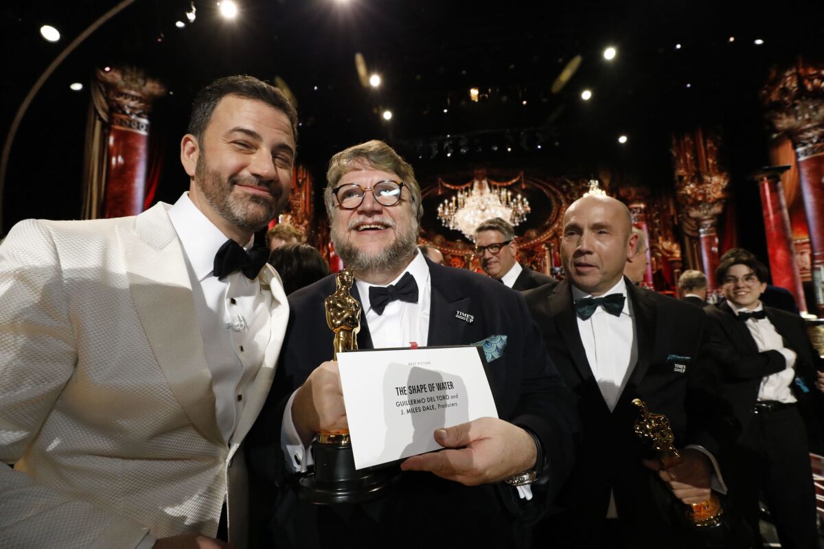 Jimmy Kimmel, from left, and Oscar winners Guillermo del Toro and J. Miles Dale at the 90th Academy Awards.