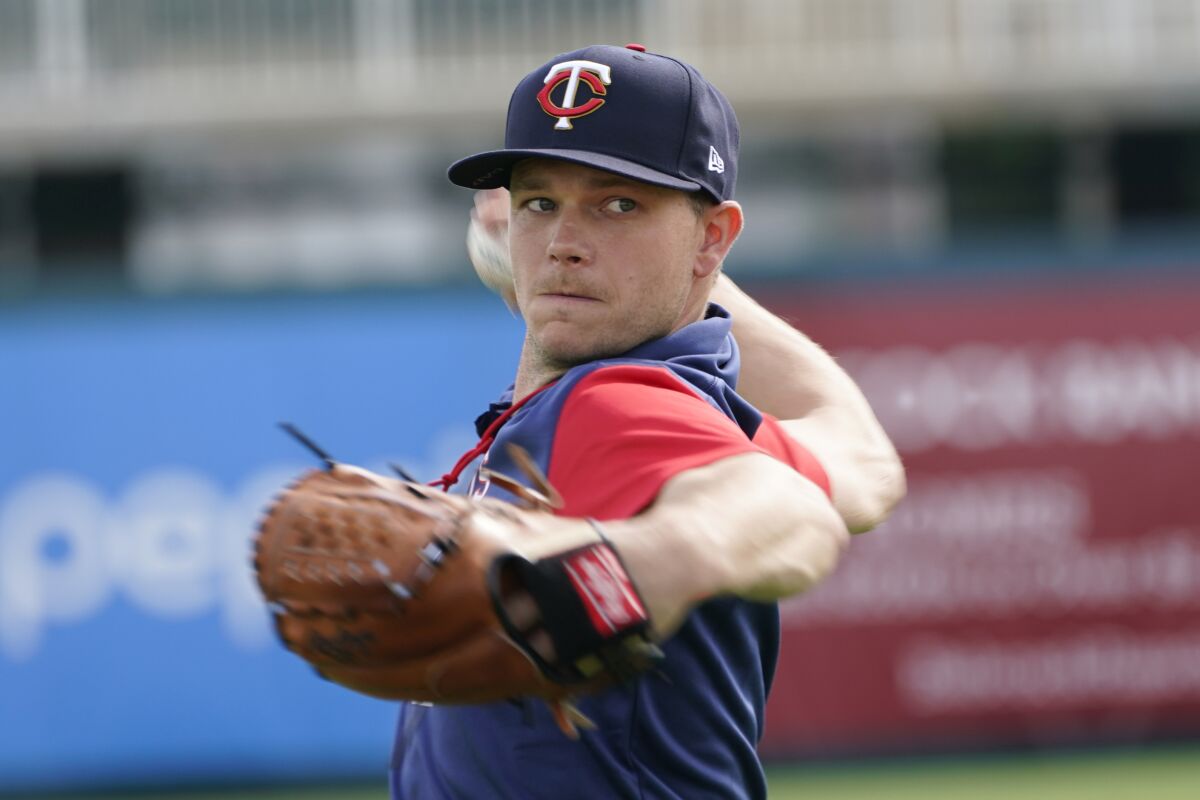 Minnesota Twins pitcher Sonny Gray warm ups during baseball spring training at Hammond Stadium Tuesday March 15, 2022, in Fort Myers, Fla. (AP Photo/Steve Helber)