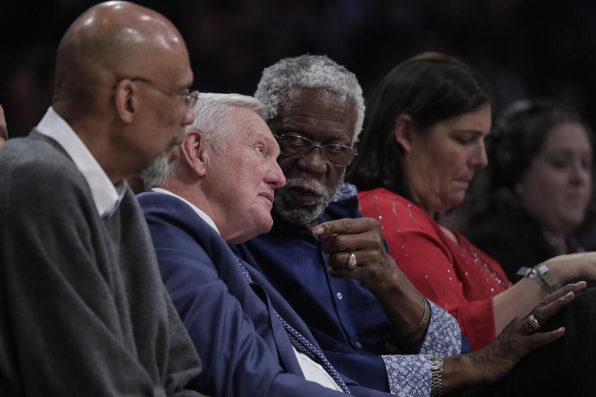 Lakers legend Jerry West chats with Celtics great Bill Russell next to Kareem Abdul-Jabbar.