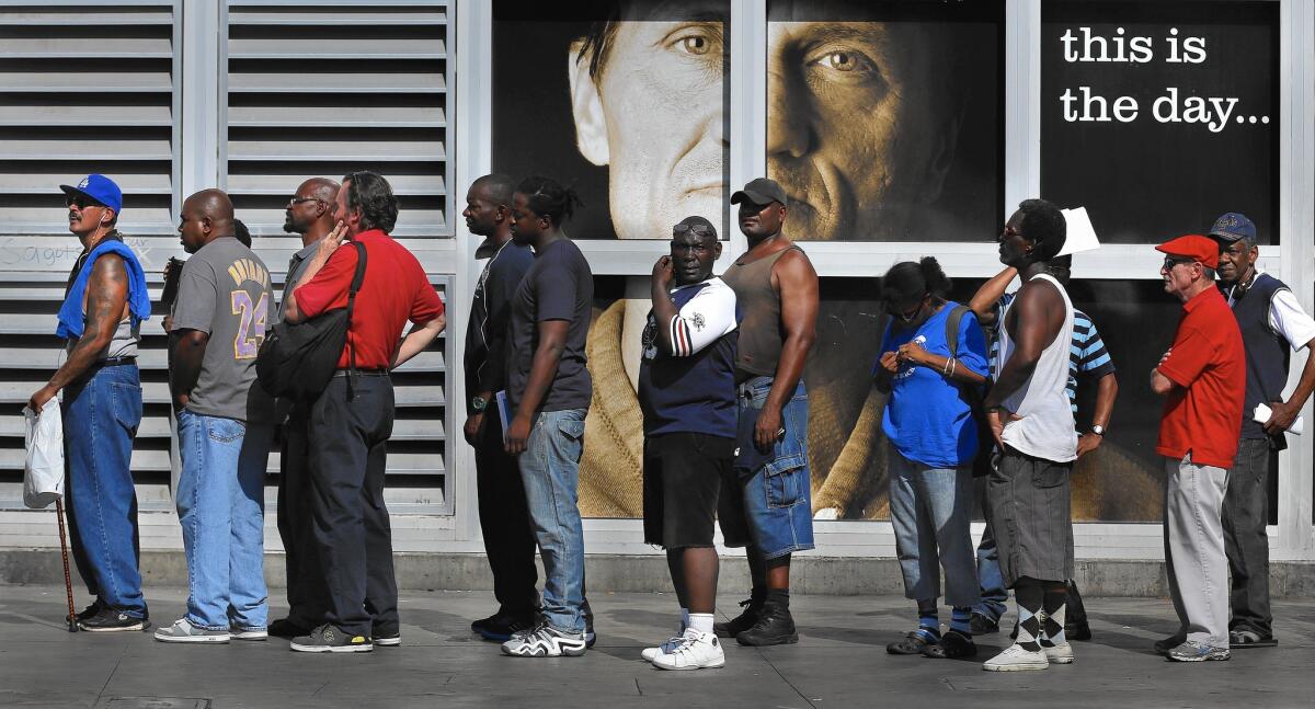 People line up for a skid row homeless court and citation clinic organized by City Atty. Mike Feuer. Participants could have tickets, fines and warrants dismissed in exchange for community service or enrollment in drug counseling or other programs.