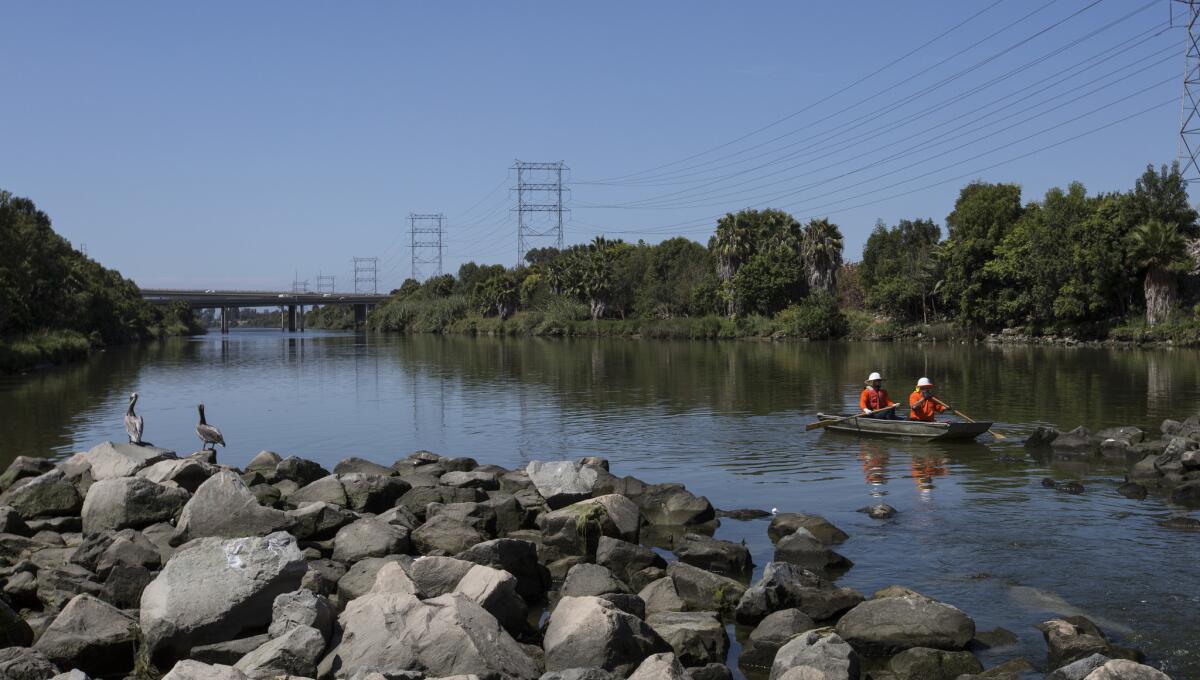 L.A. County Department of Public Works employees use a boat to collect trash from the San Gabriel River in Seal Beach.
