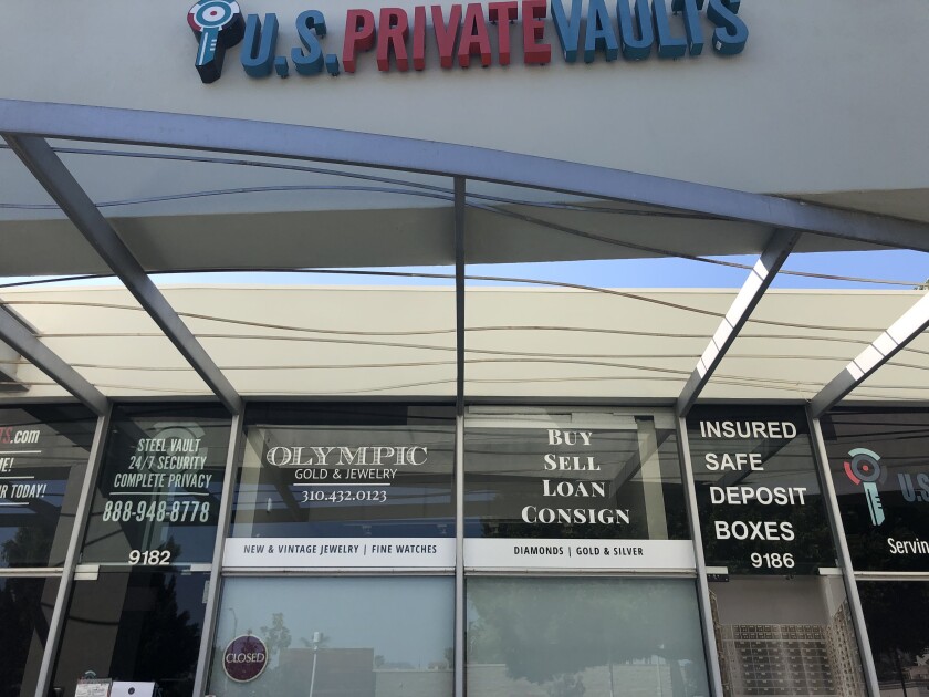 Lettering on storefront windows advertises safe deposit boxes