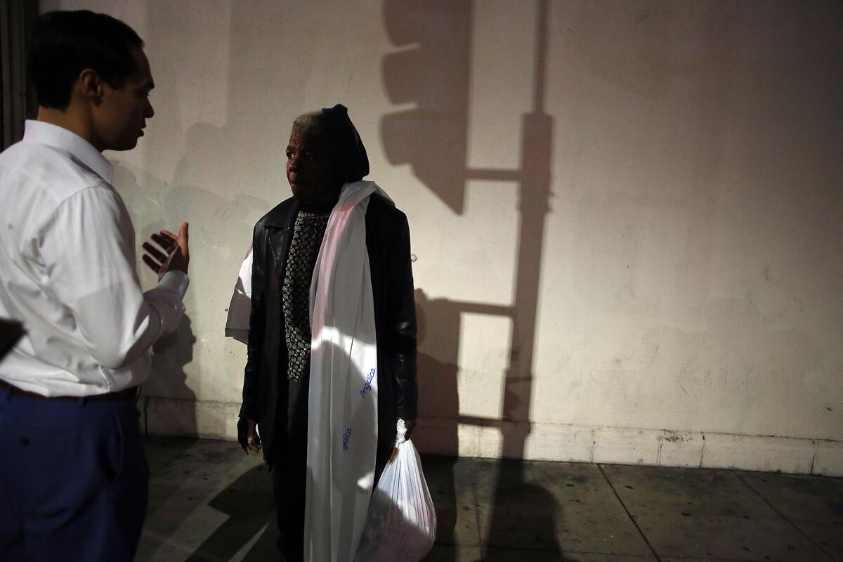 U.S. Housing and Urban Development Secretary Julian Castro meets with Jennifer Campbell, who is homeless, along skid row in Los Angeles in January.