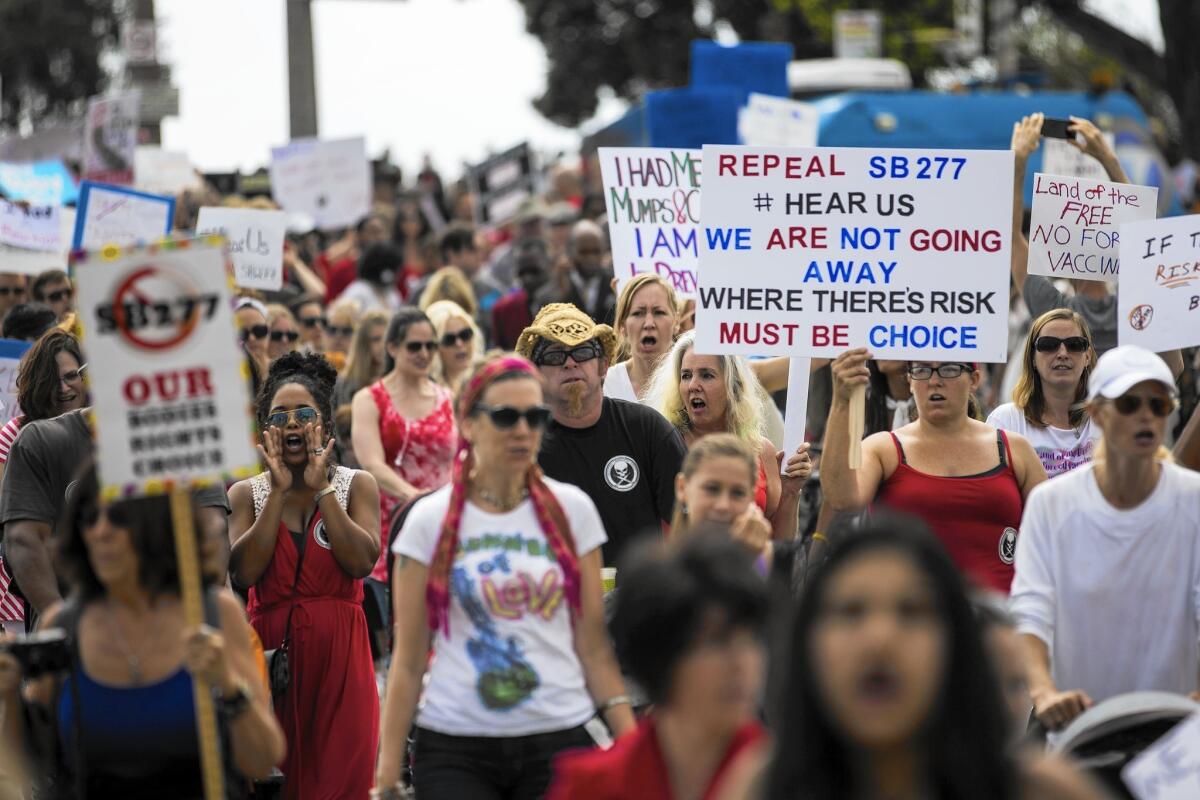 Several hundred opponents of California's new vaccination law march from the Santa Monica Pier to City Hall on Friday.