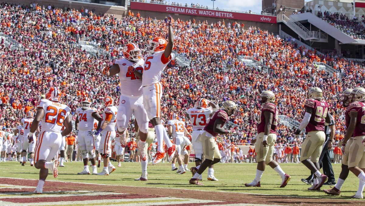 Clemson wide receiver Tee Higgins (5) and lineman Christin Wilkins celebrate Higgins' touchdown against Florida State in the first half on Saturday.