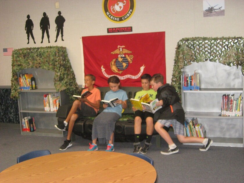 Students relax in the “jeep” couch at the military-themed Ben Carson Reading Room at Bonsall West Elementary School. The Carson Scholars Fund donated $15,000 for books and materials to refurbish a portable classroom to encourage leisure reading.