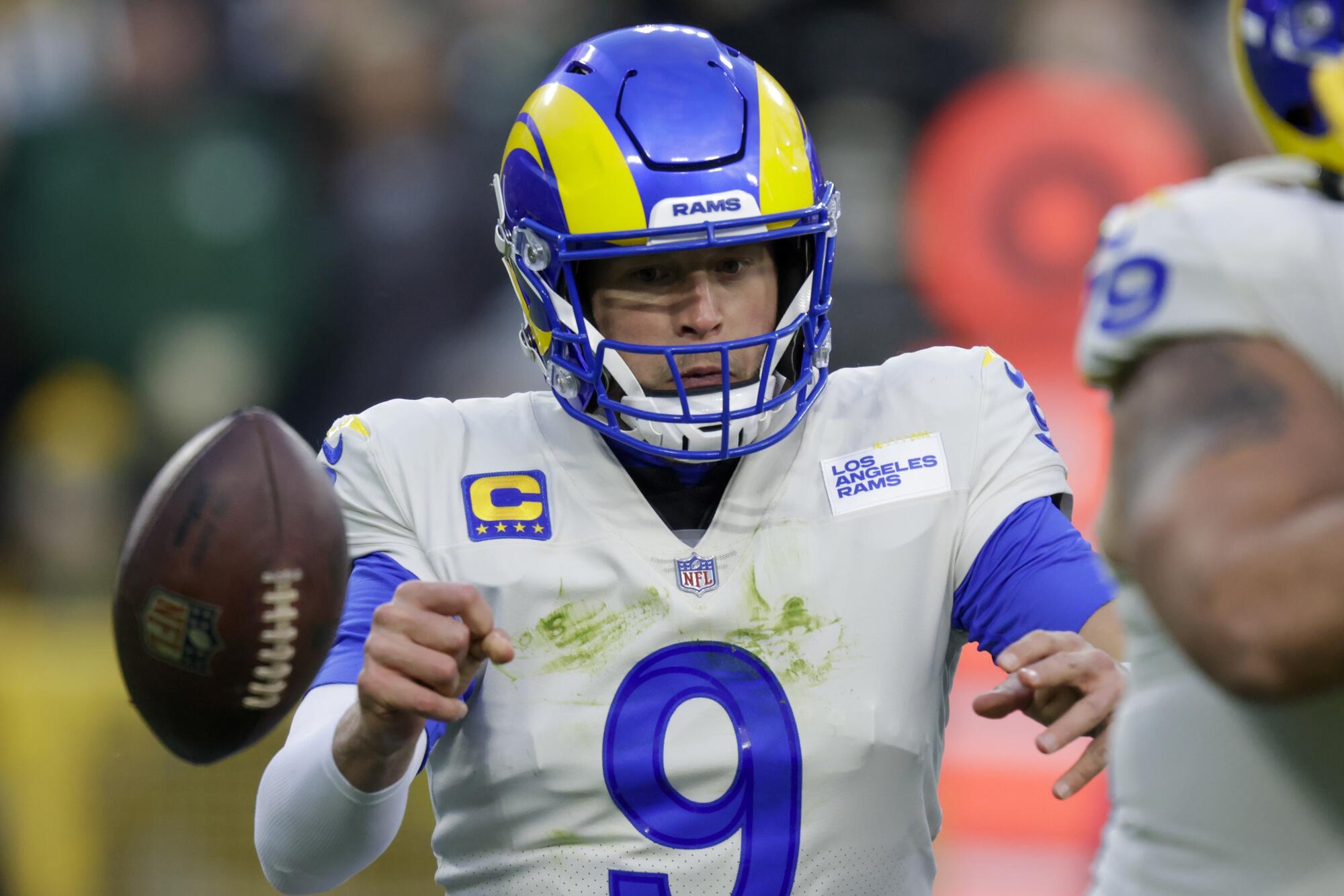 Rams quarterback Matthew Stafford fumbles during the first half against the Packers.