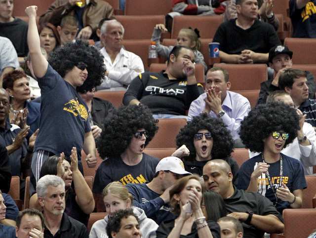Fans cheer after a made three-pointer by UC Irvine's Michael Wilder during the second half against Long Beach State in a Big West Basketball Tournament semifinal game Friday at Honda Center.