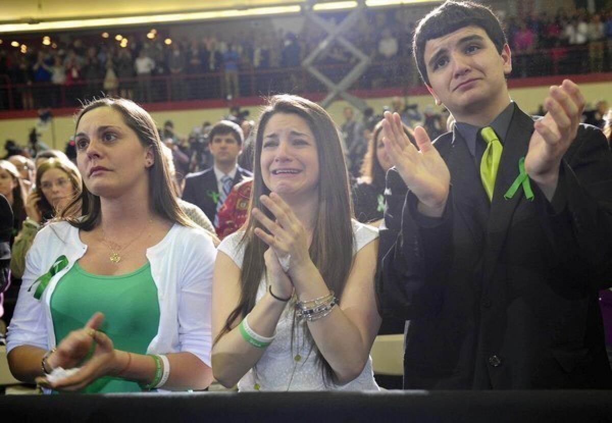 Karlee Soto, center, whose sister Victoria Soto was killed in the school shooting in Newtown, Conn., listens to President Obama speak at the University of Hartford.