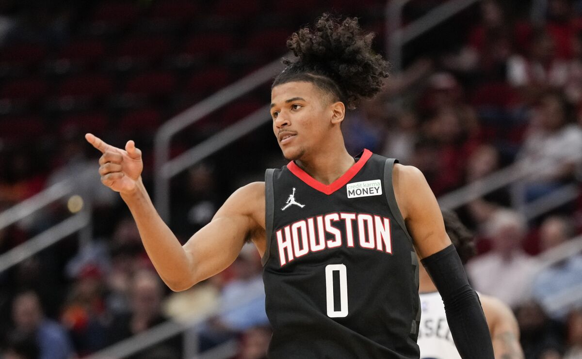 Houston Rockets guard Jalen Green reacts after making a 3-point basket during the second half of the team's NBA basketball game against the Minnesota Timberwolves, Sunday, April 3, 2022, in Houston. (AP Photo/Eric Christian Smith)