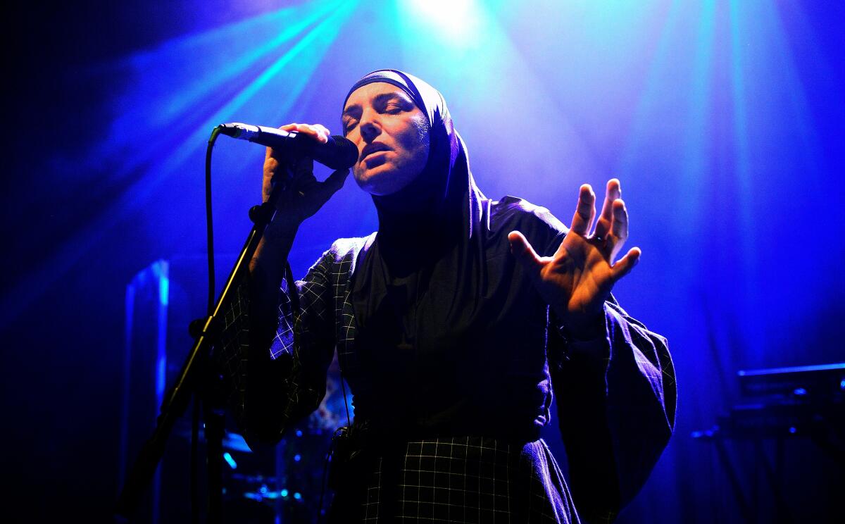 Sinead O'Connor performs on stage.