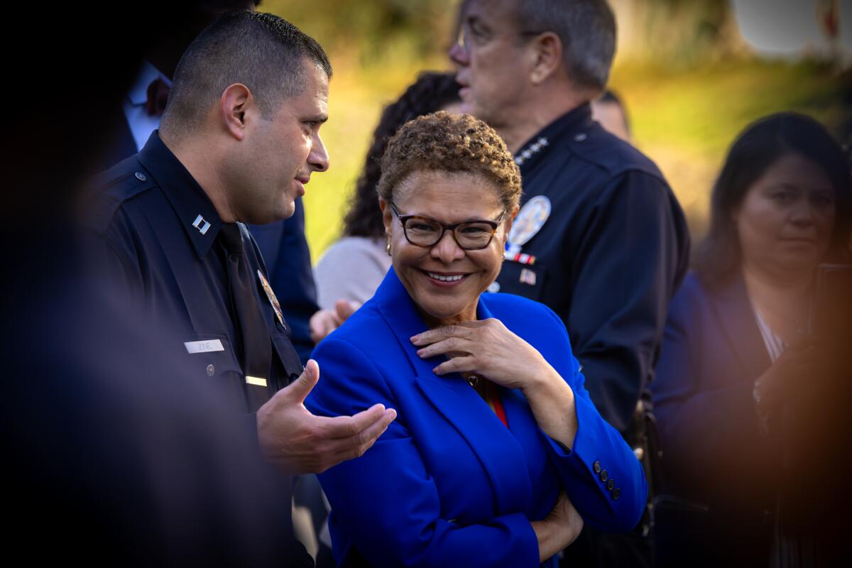 L.A. Mayor Karen Bass smiling at an LAPD event with officers in uniform