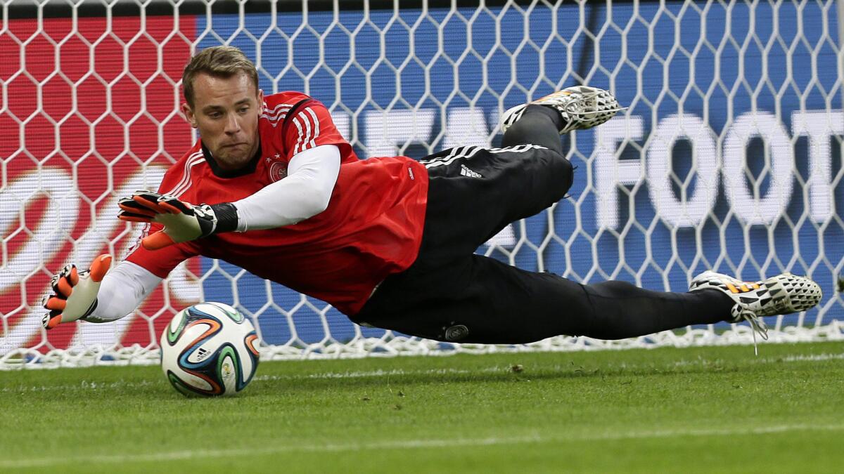 Germany goalkeeper Manuel Neuer makes a save during a team training session Monday. Bruce Arena believes the Germans will prevail over Brazil in the World Cup semifinals Tuesday.