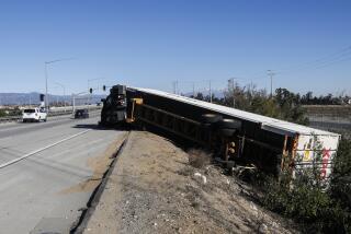 FONTANA, CA - NOVMEBER 16, 2022: A big rig lays on its side after strong winds toppled the 18-wheeler on an on-ramp to the 210 freeway on November 16, 2022 in Fontana, California. A high wind warning is in effect for the Inland Empire until Wednesday evening. (Gina Ferazzi/Los Angeles Times)