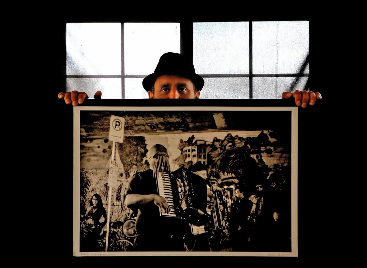 L.A. photographer Rafael Cardenas stands behind his photograph titled "Dorian Wood and Killsonic."