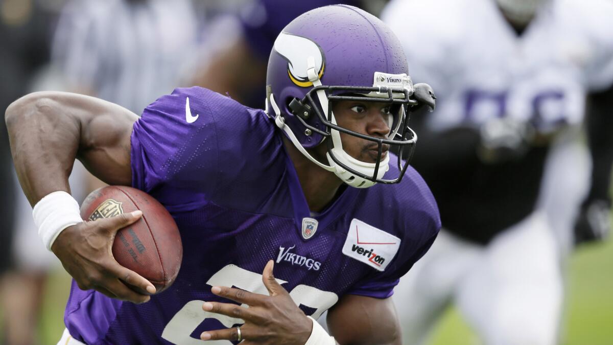 Minnesota Vikings running back Adrian Peterson, carrying the ball during a training camp session in July, will not play again this season.