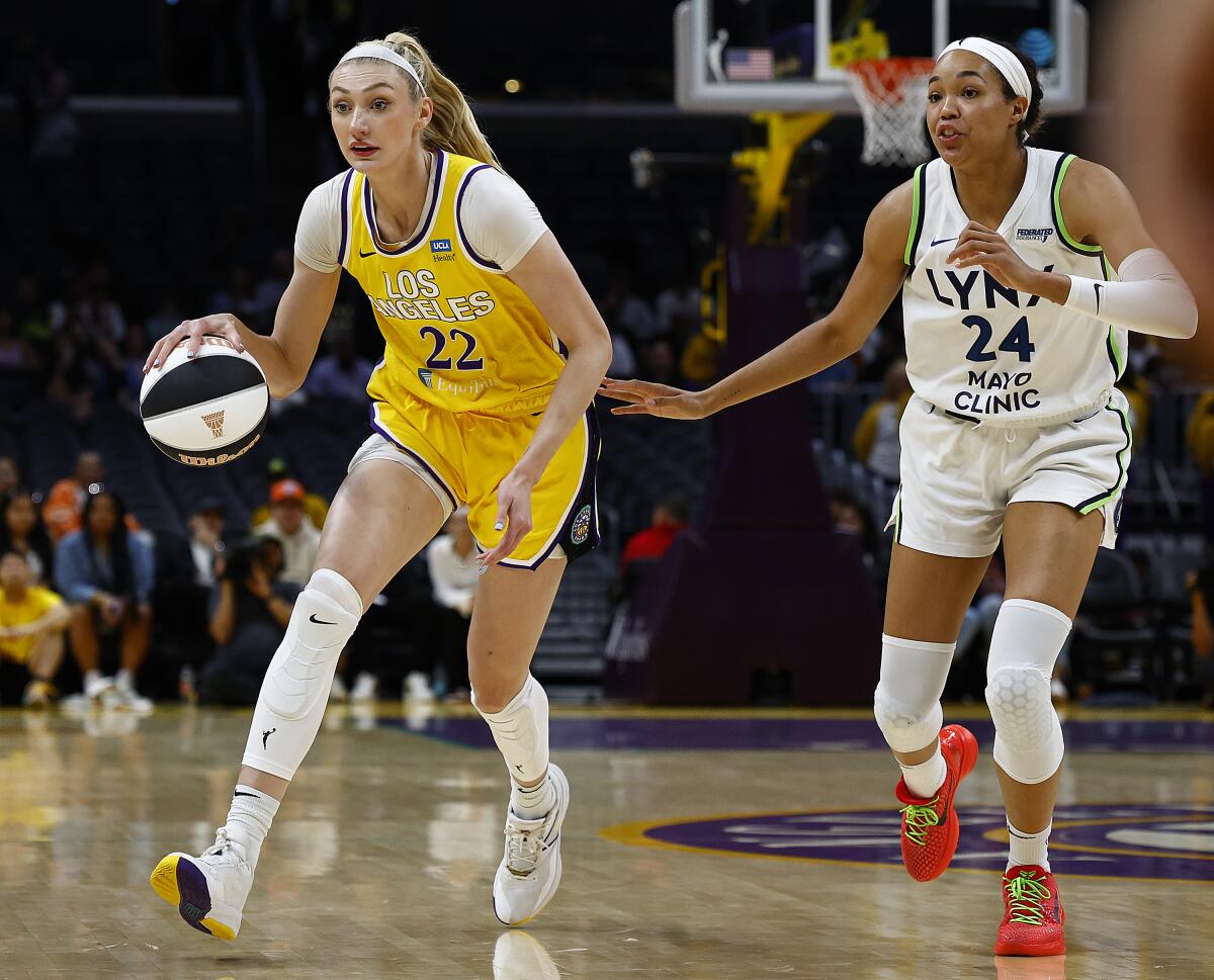 Lakers center Cameron Brink controls the ball in front of the Minnesota Lynx's Napheesa Collier