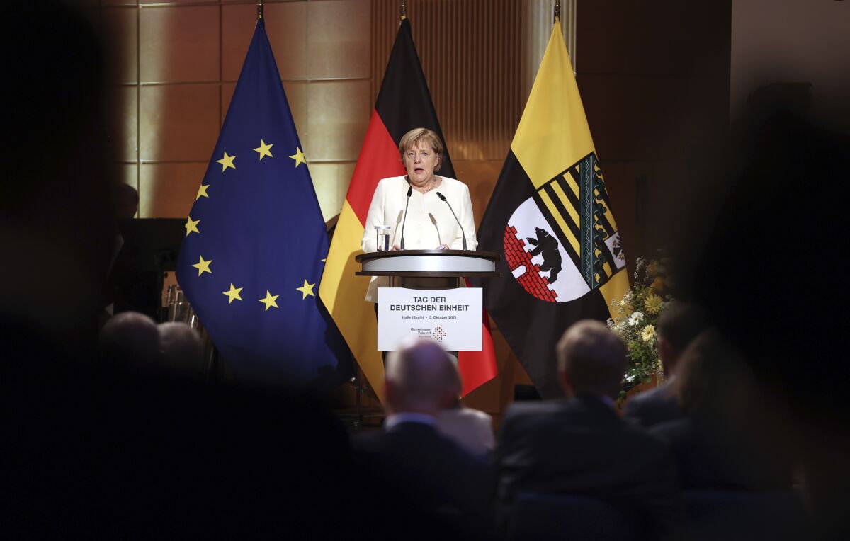 Federal Chancellor Angela Merkel (CDU) speaks at the ceremony marking German Unity Day in the Handel Hall in Halle/Saale, Sunday, Oct. 3, 2021. ( Jan Woitas/Pool via AP)