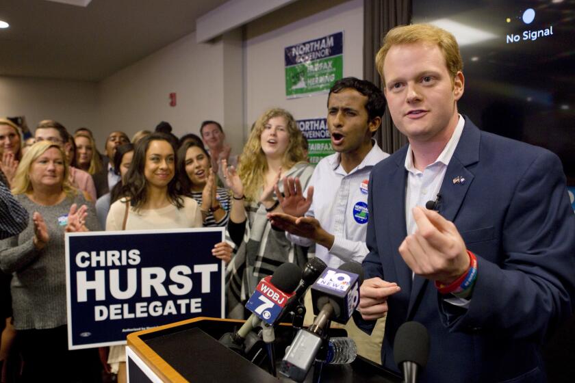 Democrat Chris Hurst defeated Republican incumbent Joseph Yost to win House District 12. Hurst, right, celebrates with a packed room of supporters in Blacksburg, Va. on Nov. 7, 2017.