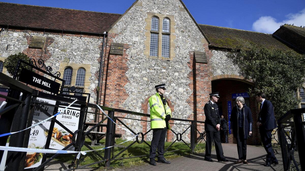 Britain's Prime Minister Theresa May stands outside the Mill pub on Thursday as she views the area where former Russian double agent Sergei Skripal and his daughter were found critically ill, in Salisbury, England.