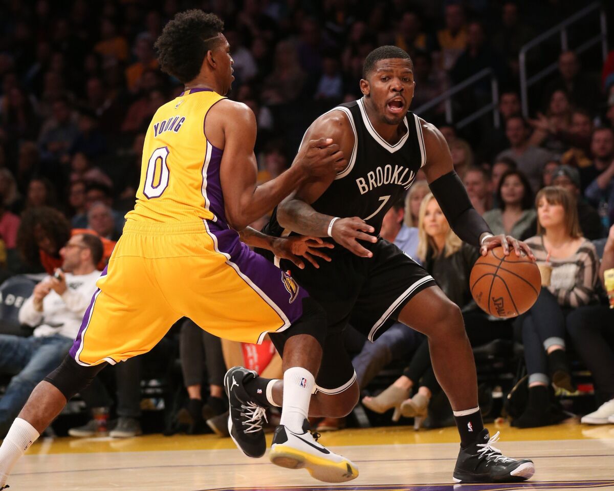 Nets guard Joe Johnson looks to drive against Lakers guard Nick Young during a game last season.