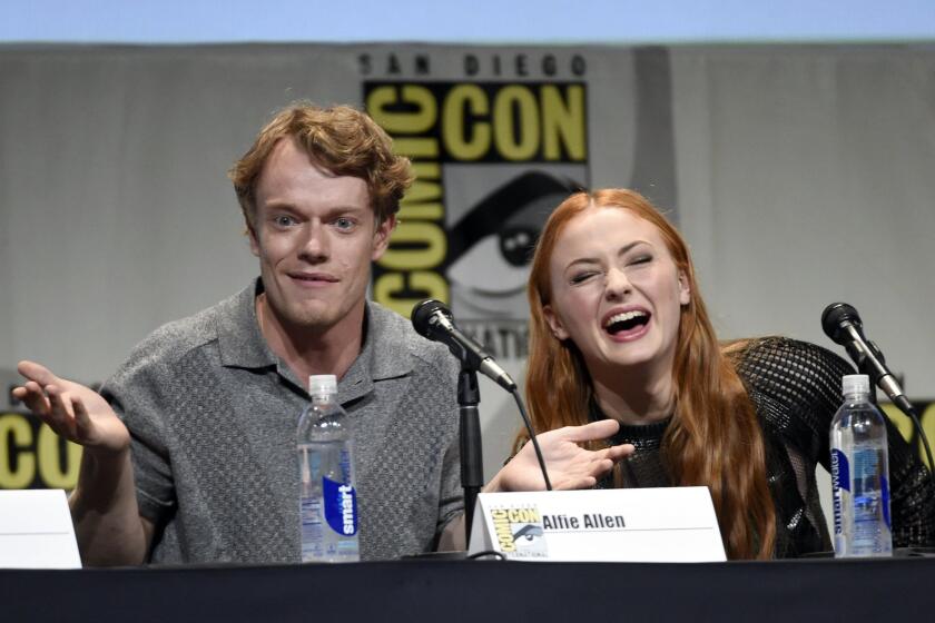 Alfie Allen and Sophie Turner at the "Game of Thrones" panel at Comic-Con International on July 10.