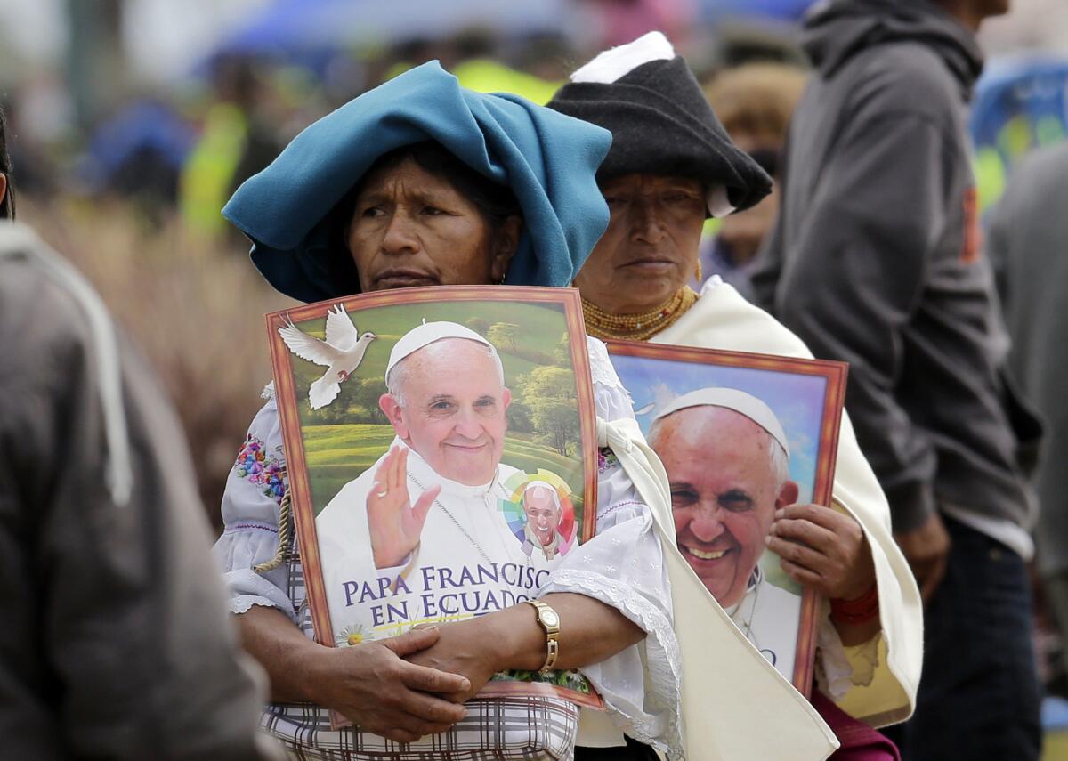 Indígenas otavaleños sostienen posters con la imagen del papa Francisco a su llegada al parque Bicentenario de Quito, Ecuador, donde el pontífice ofició una misa multitudinaria el 7 de julio de 2015. Una de las lecturas de la misa fue hecha en quichua, la lengua indígena dominante en la nación andina. (Foto AP/Dolores Ochoa)