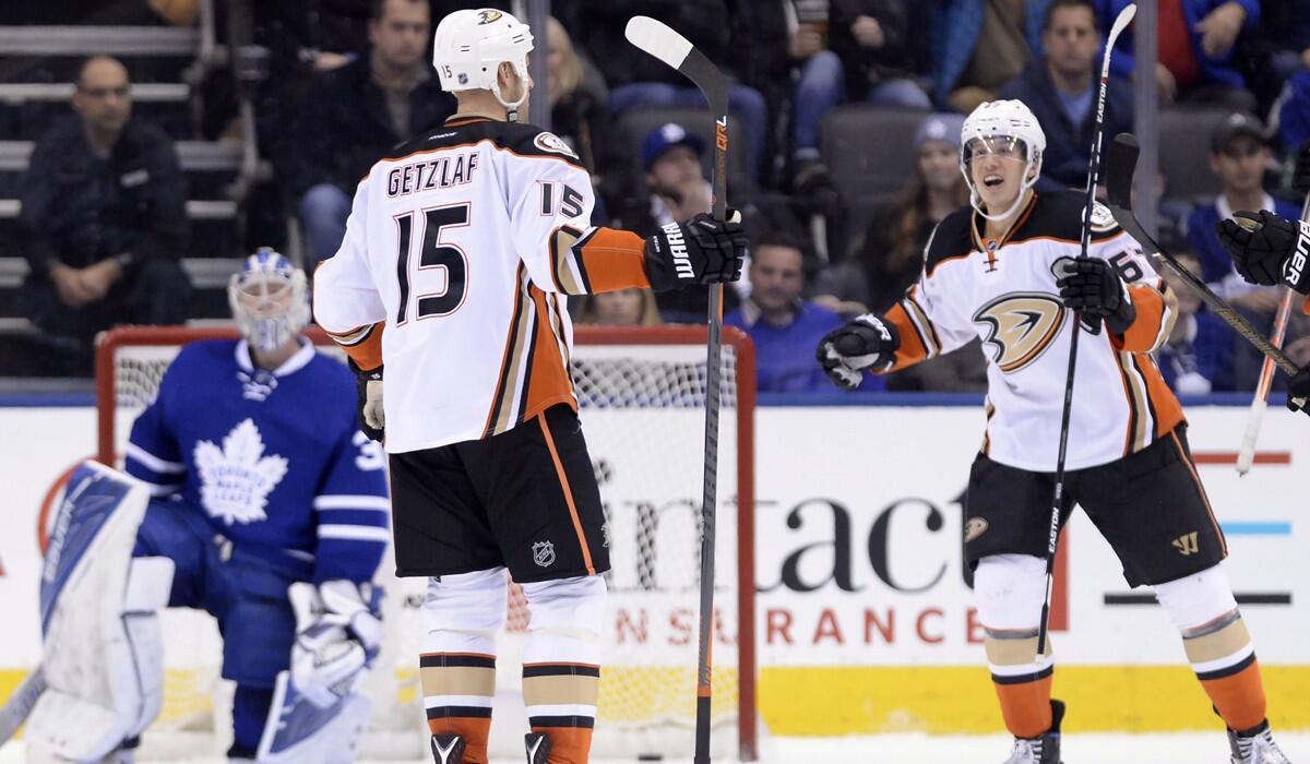 Ducks center Ryan Getzlaf (15) celebrates his goal with teammate center Rickard Rakell (67) during second period Monday.