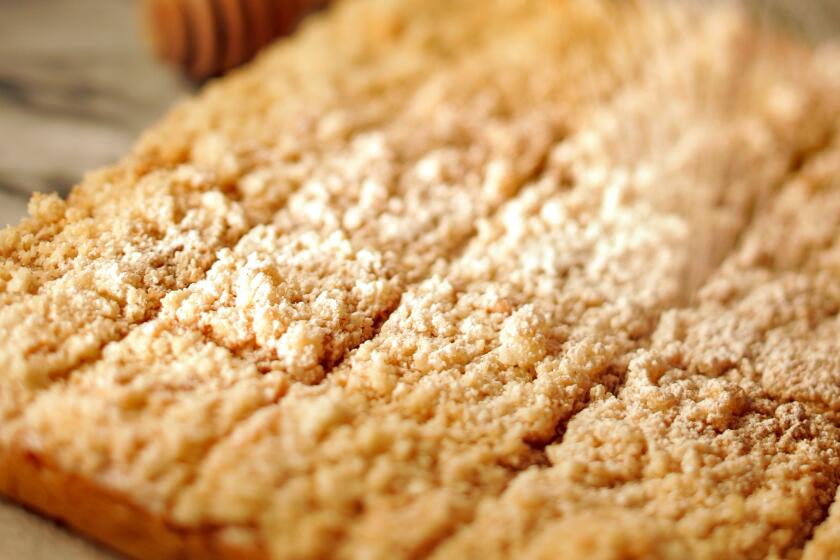 Close up of honey shortbread being sprinkled with powder sugar and cinnamon.