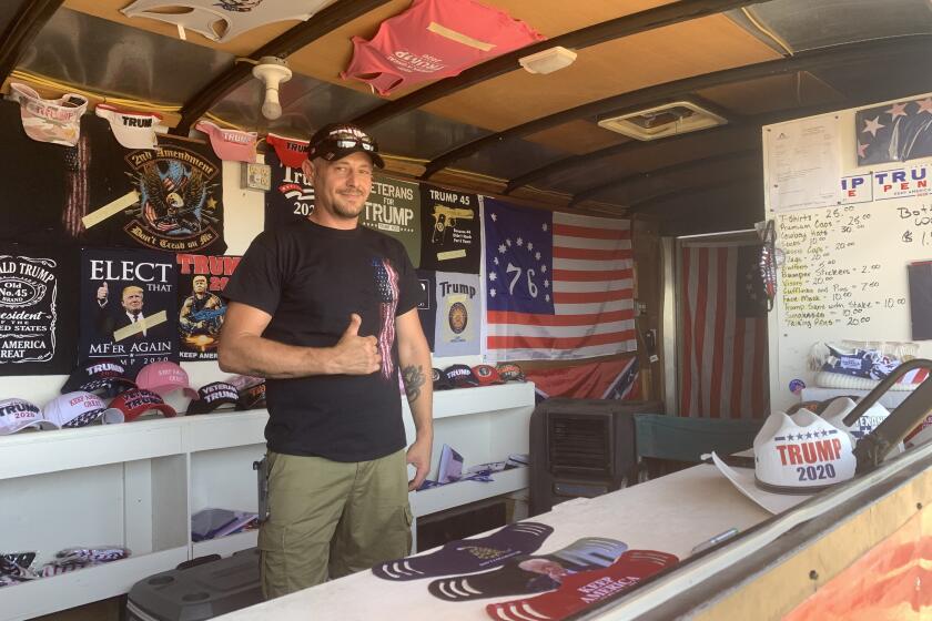 Don Caple sells face masks from the Trump Trailer outside Cadillac Ranch in Amarillo, Texas.