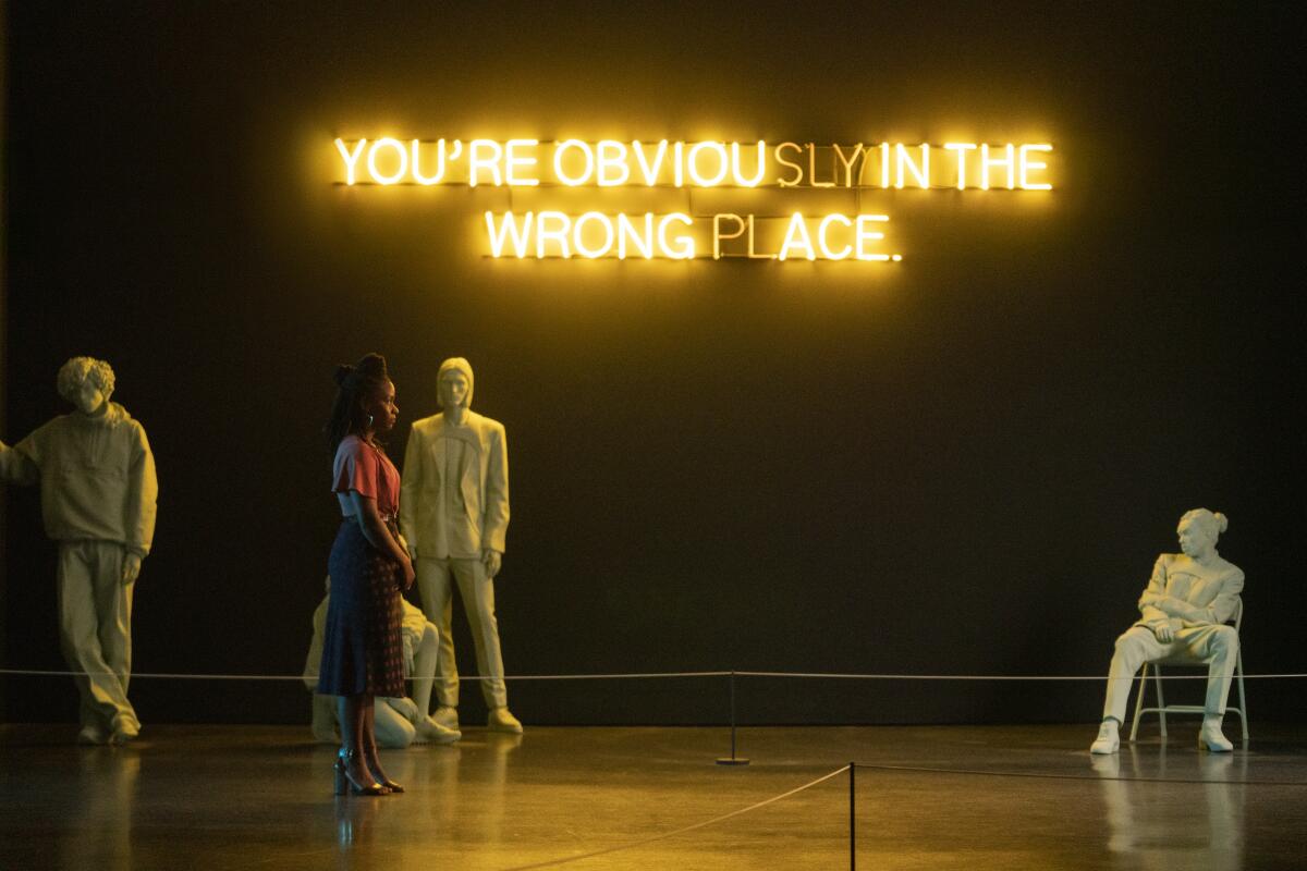 A woman stands amid four figures in various poses underneath a sign that says "You're obviously in the wrong place."