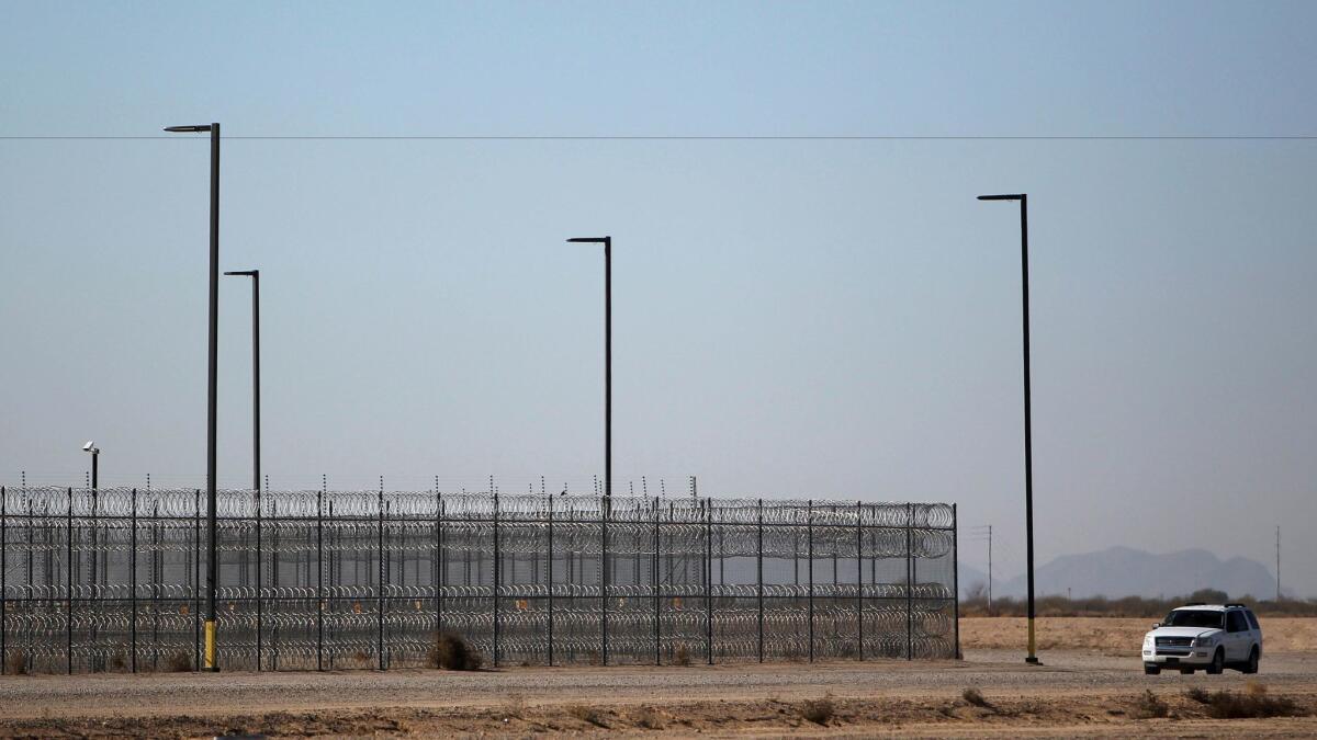 An unmarked police truck patrols the outside of a detention center in Eloy, Ariz. on Jan. 20.