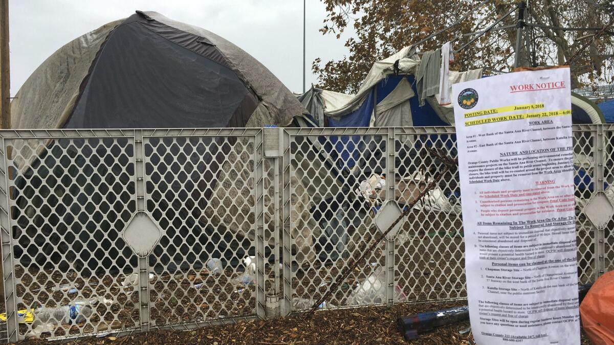 A sign warning homeless residents they'd need to move out of a 2-mile long encampment was posted in Anaheim in early January.