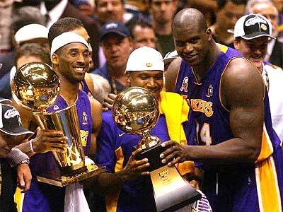 Kobe Bryant, Lindsey Hunter and Shaquille O'Neal posed with NBA hardware after clinching the 2001-2002 title in New Jersey.