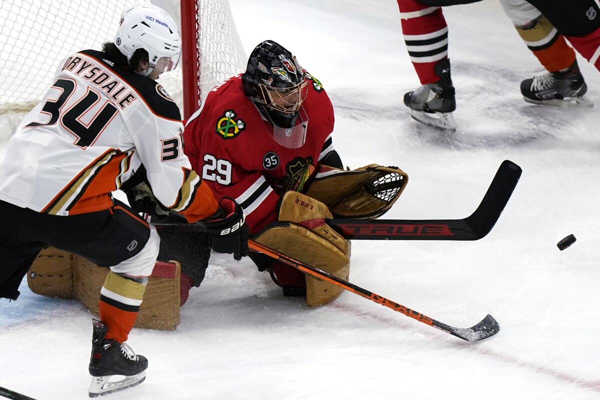Blackhawks goalie Marc-Andre Fleury saves a shot by Ducks defenseman Jamie Drysdale during the first period.
