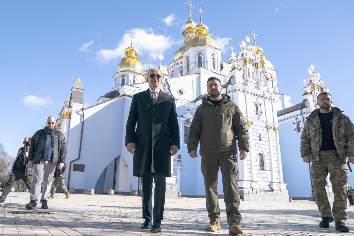 President Biden and Volodymyr Zelensky walk together in Kyiv.