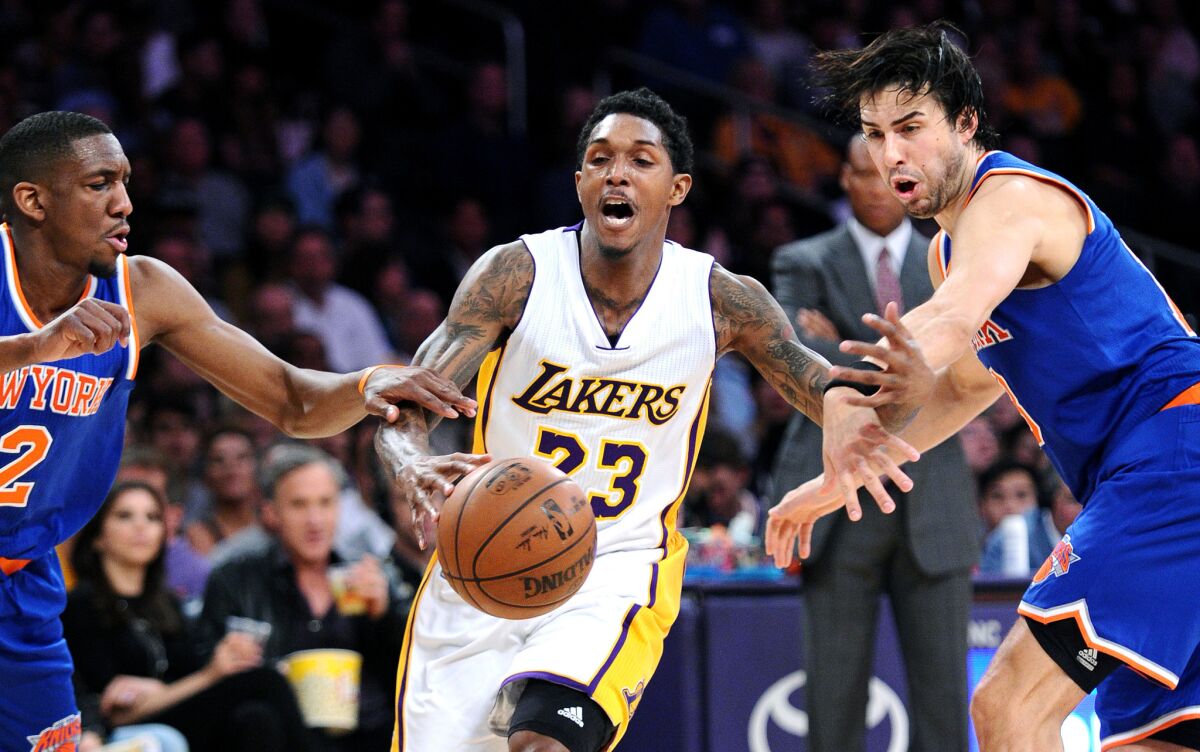 Lakers guard Lou Williams is fouled by Knicks guard Sasha Vujacic, right, as Langston Galloway tries to help on defense on March 13.